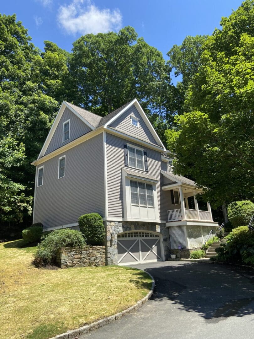 Gray house with a garage and driveway.