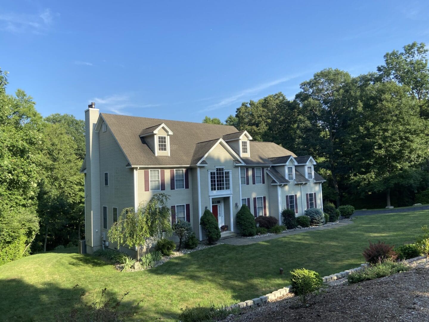 Large suburban house, green lawn.