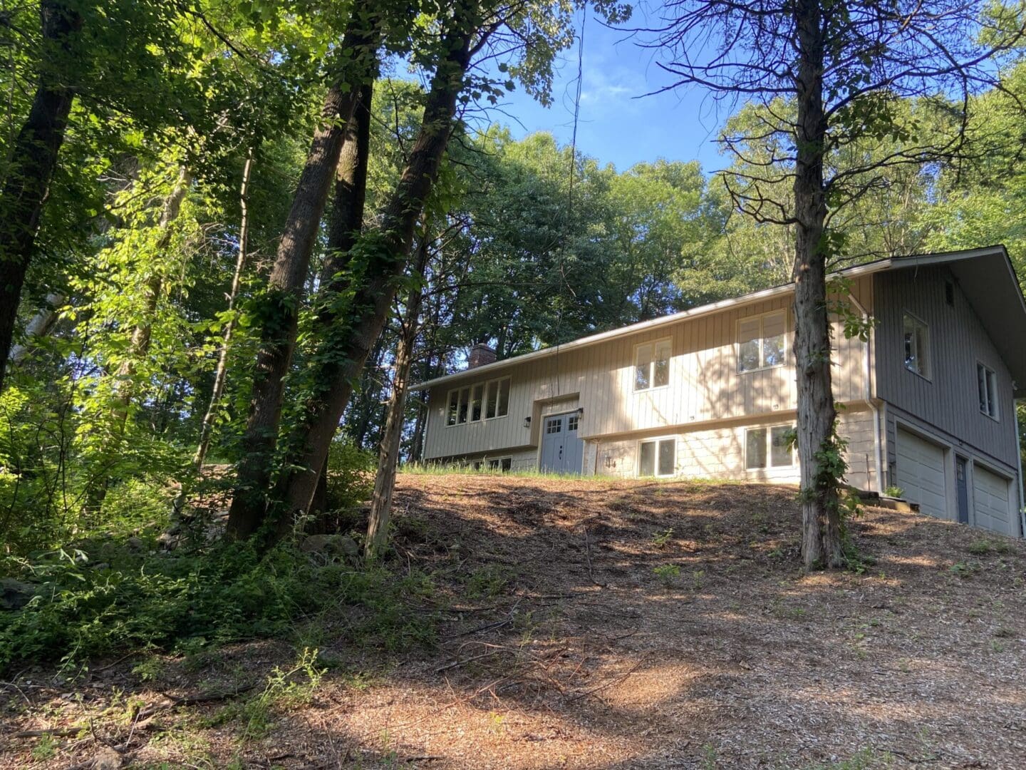 House nestled in wooded hillside