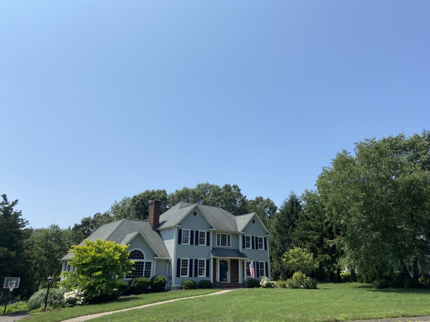 Two-story house with a green lawn.