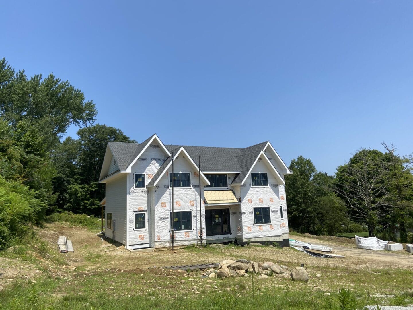 New house under construction in woods.