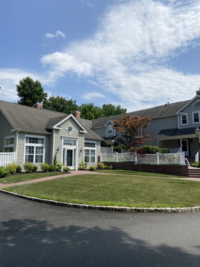 Gray house with white trim and a driveway.