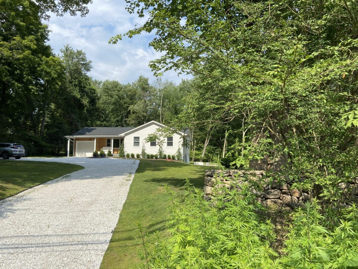 White house with a gravel driveway.