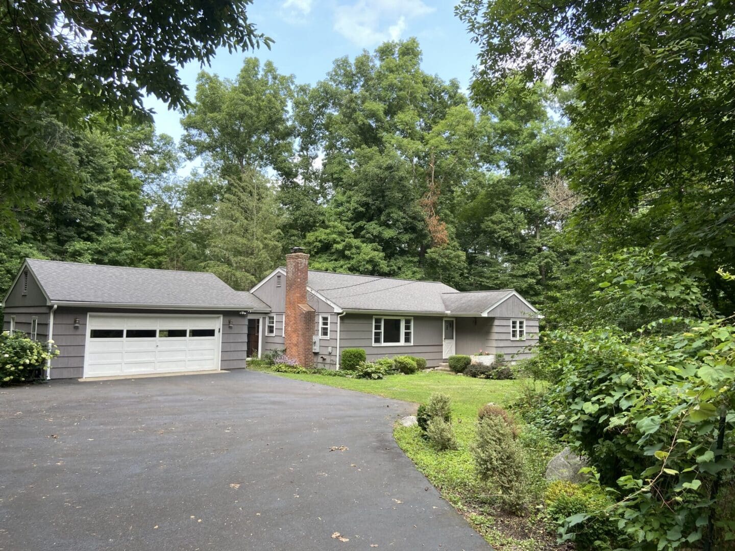 Gray house with white garage door.