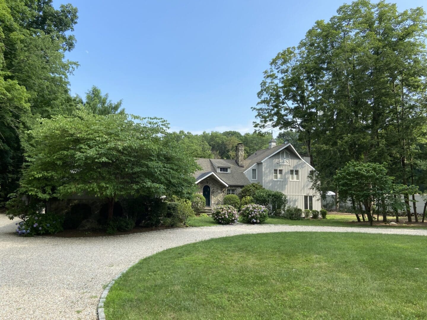 Stone and wood house, green lawn.