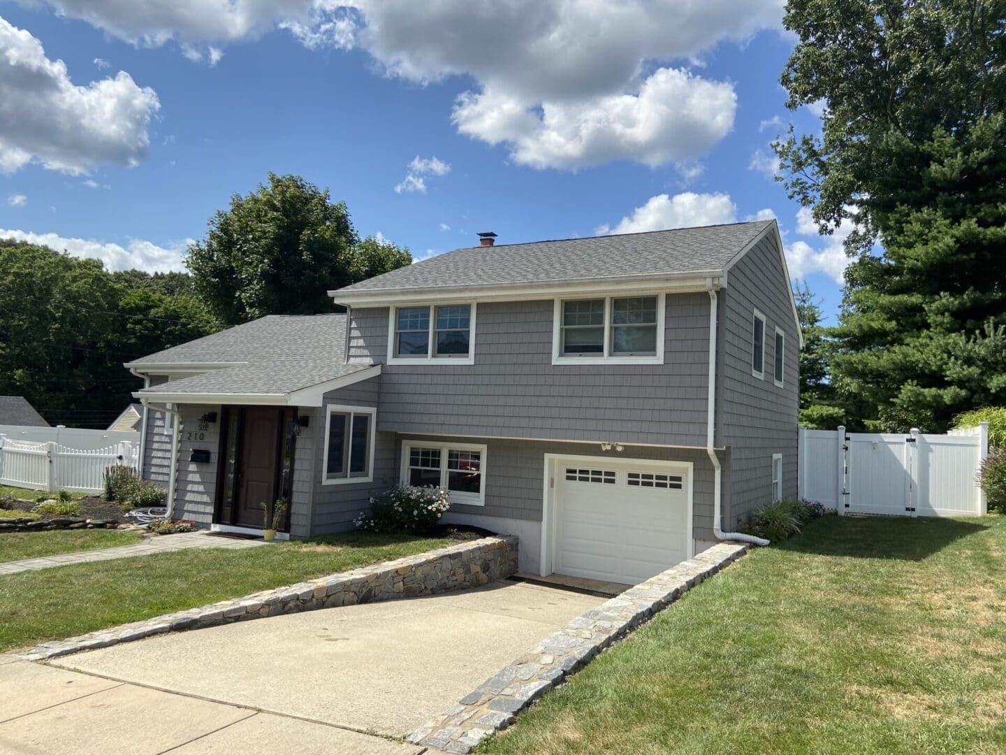 Gray house with white garage door.