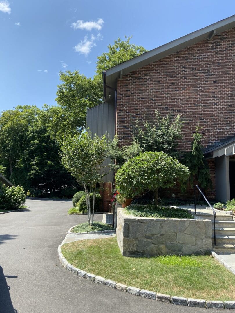 Brick house with stone retaining wall.