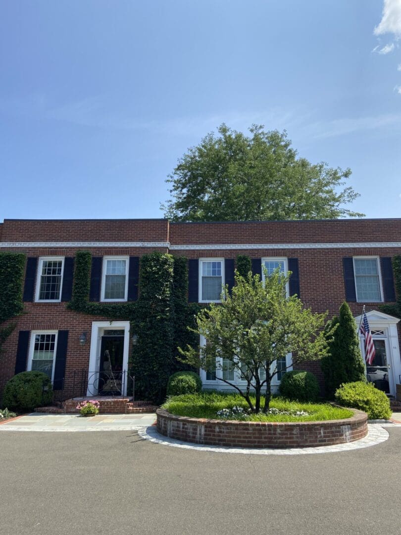 Brick house with ivy and an American flag.