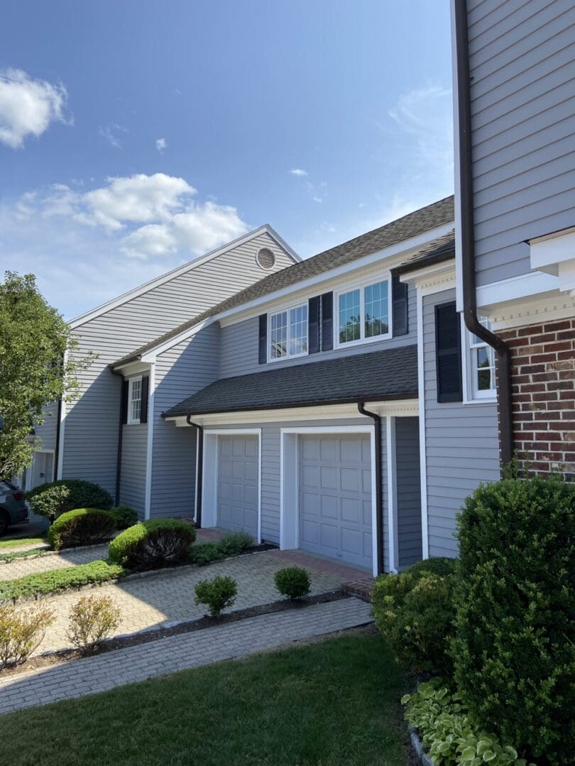 Gray house with two garage doors.