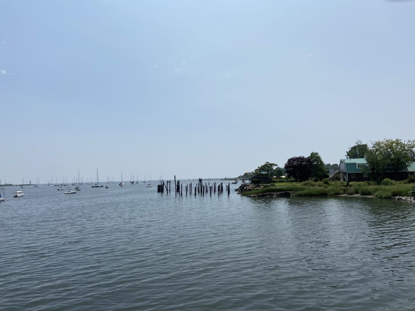 Boats docked in calm harbor waters.