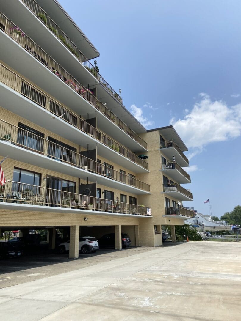 Multi-story apartment building with parking lot.