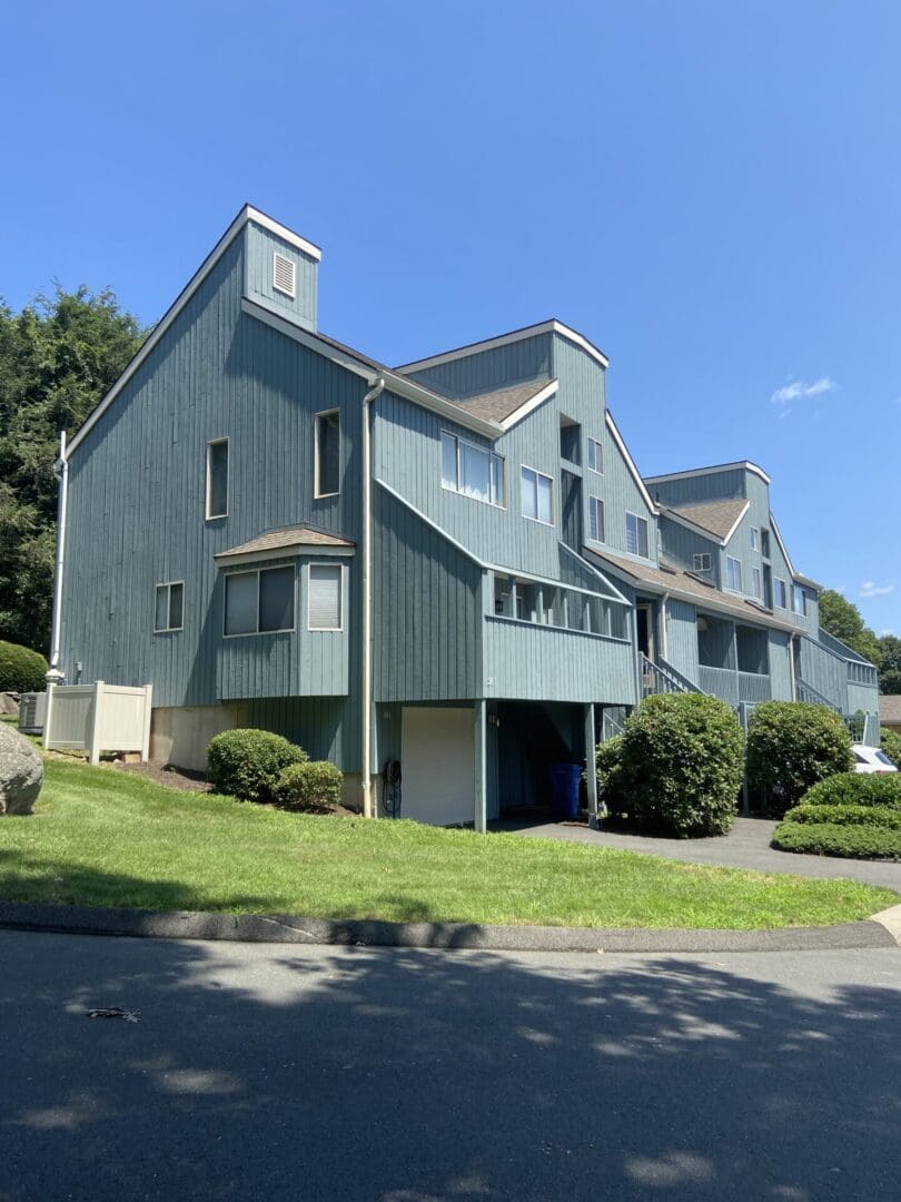 Blue multi-family home with garage door.