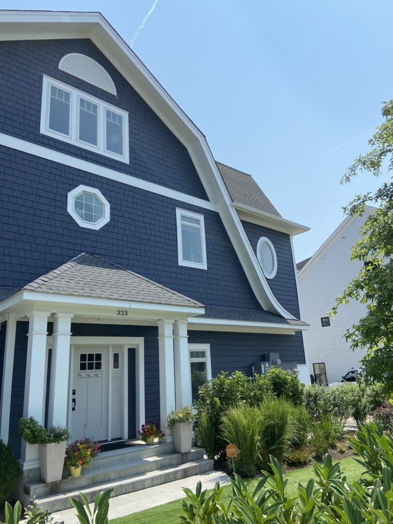 Blue house with white trim and a porch.