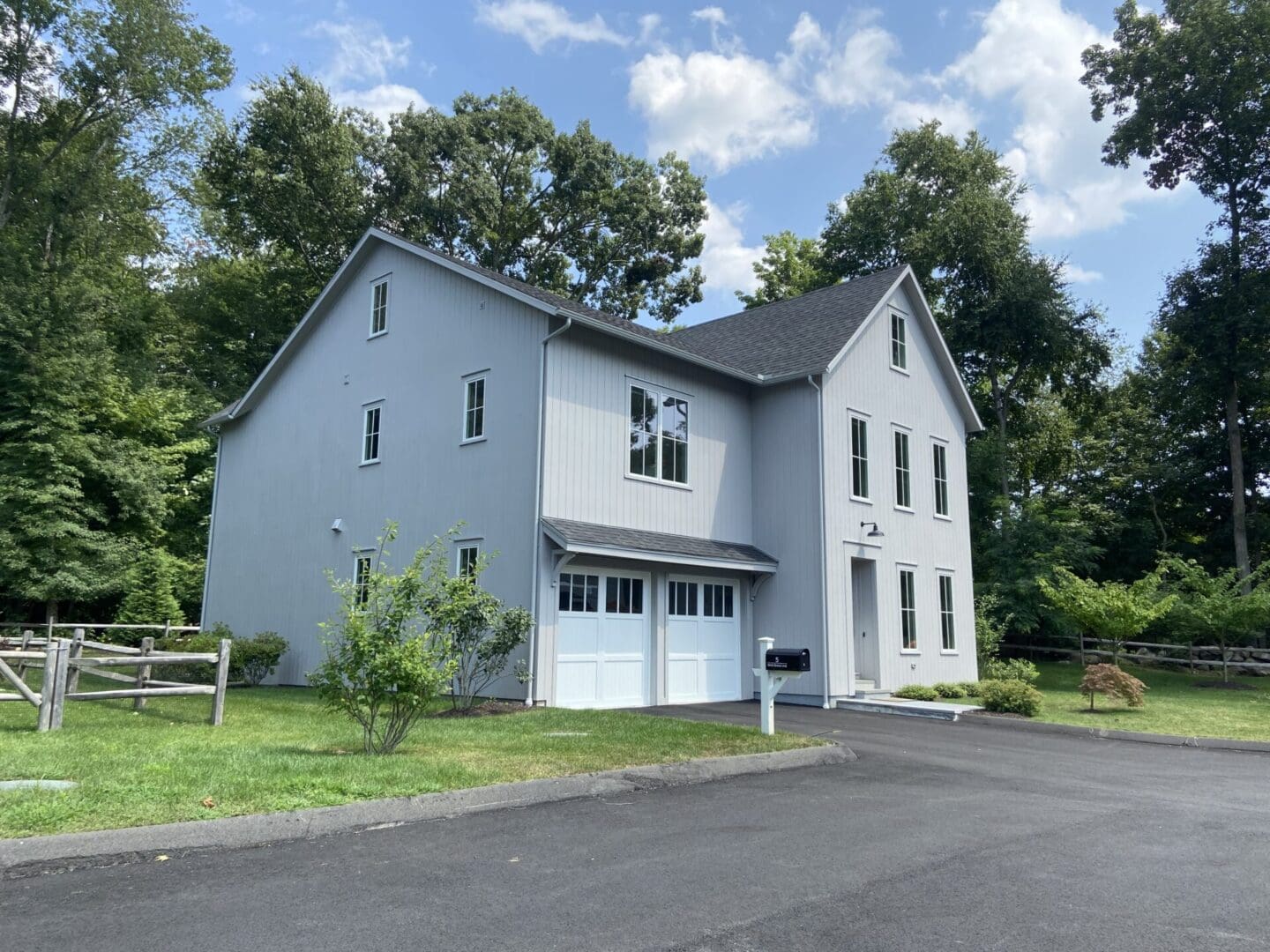 Gray house with white garage doors.