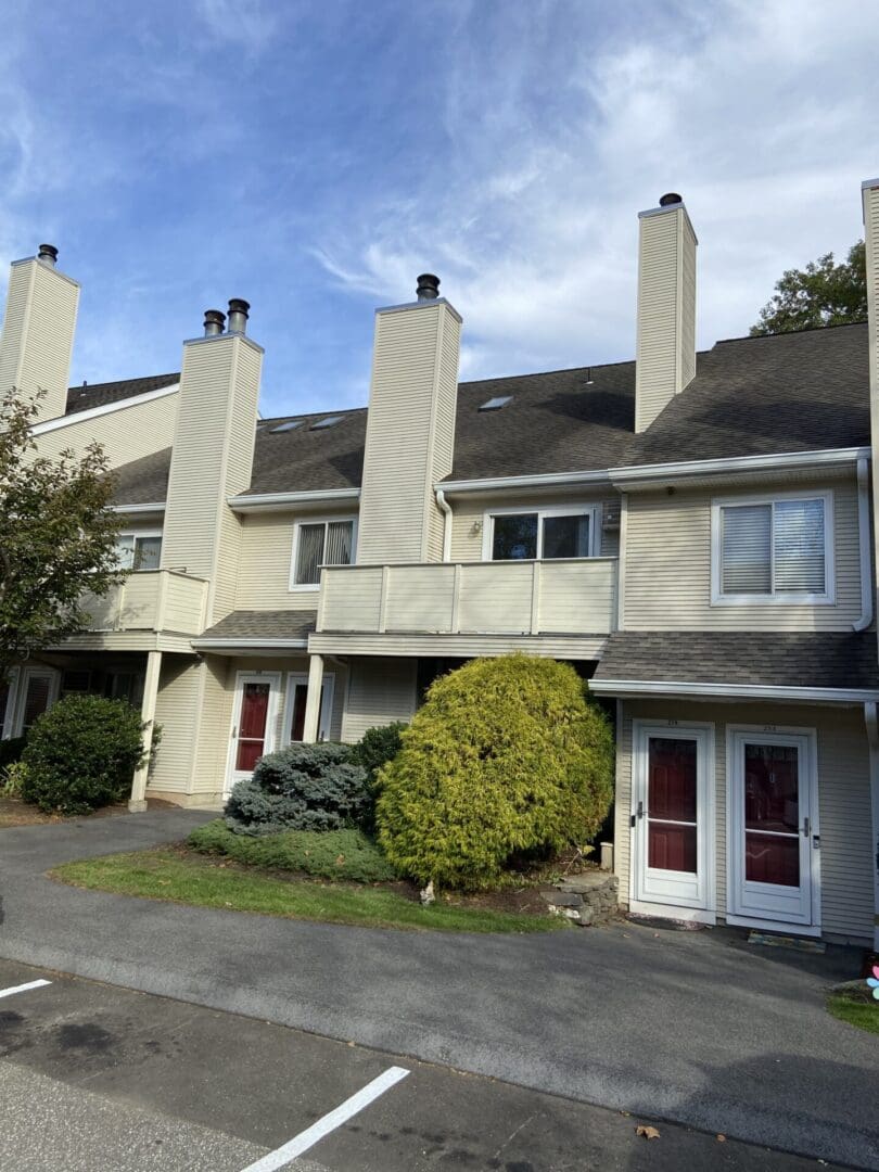 Tan townhouse with two front doors.