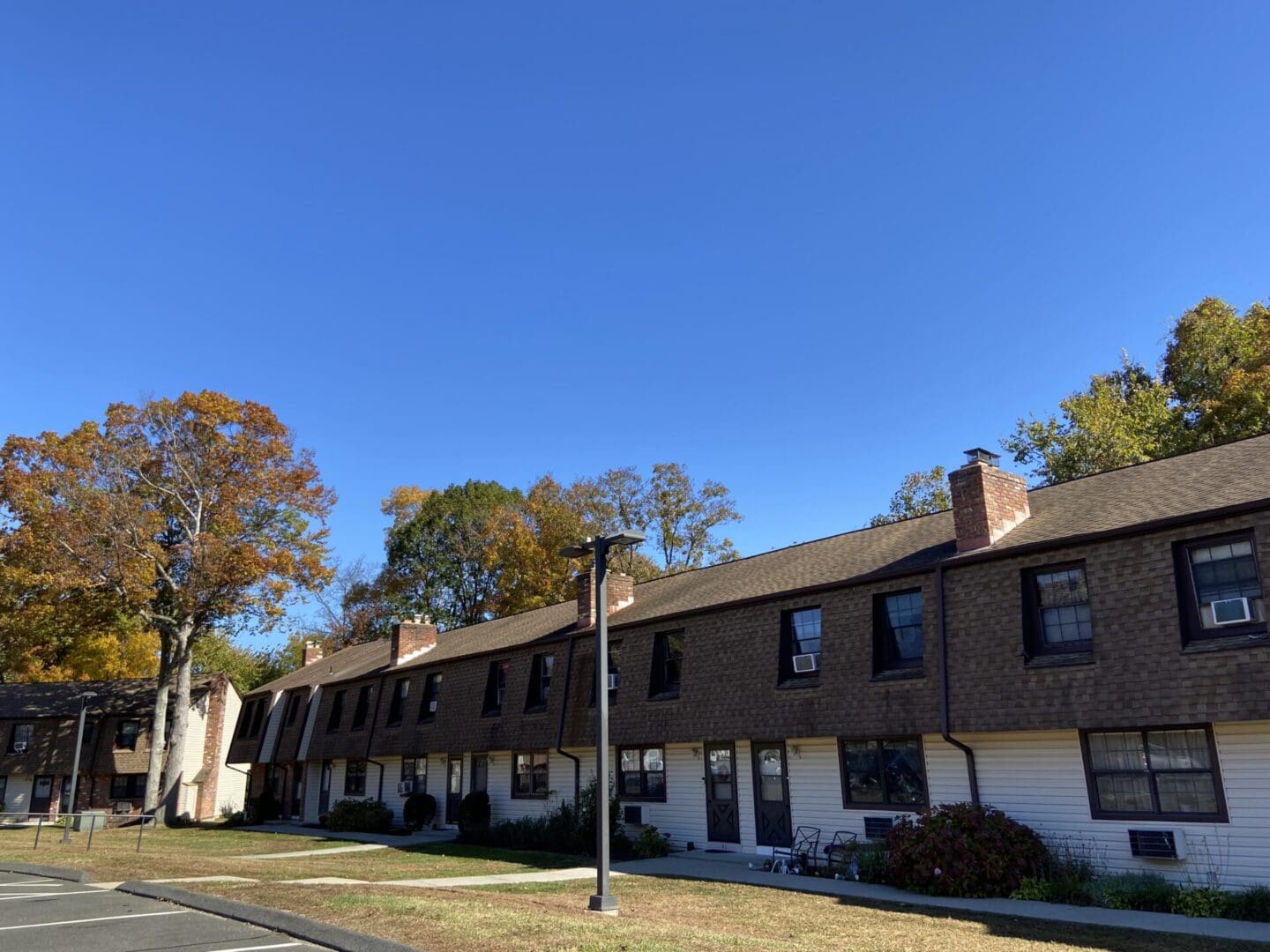 Brown roofed townhouses with blue sky.